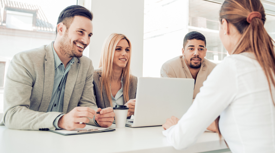 of A candidate having a one-on-one interview in a modern office setting, explaining their reasons for leaving a previous role, highlighting transparency and professional communication during the hiring process.